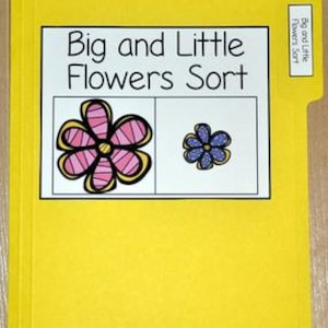 May include: A yellow file folder with the text "Big and Little Flowers Sort" on a white label. The label shows a large pink and a small blue flower. A smaller label on the tab also reads "Big and Little Flowers Sort".