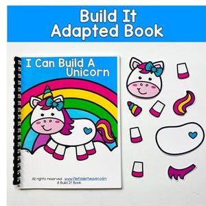 May include: A spiral-bound book titled "I Can Build A Unicorn" with a cartoon unicorn illustration and a rainbow. Accompanying cut-out pieces include a unicorn head, body, and other parts. The text "Build It Adapted Book" is at the top.