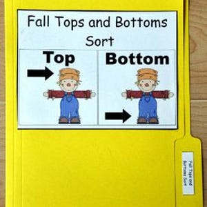 May include: A yellow file folder with a white label that reads "Fall Tops and Bottoms Sort." The label features illustrations of a scarecrow with arrows pointing to "Top" and "Bottom." The file tab also has a label that reads "Fall Tops and Bottoms Sort."