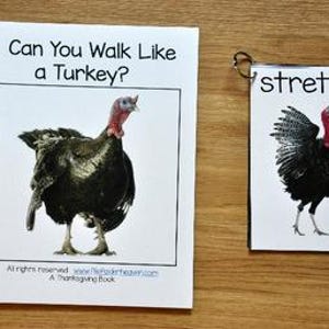 May include: A spiral-bound book and a card with turkey illustrations. The book cover reads "Can You Walk Like a Turkey?" and the card says "stretch". Both feature a black turkey with a red wattle. The background is a wooden surface.
