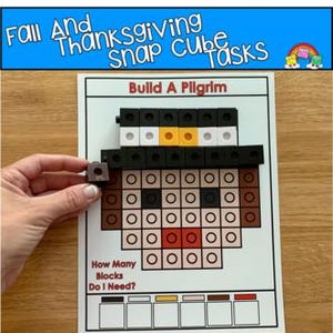 May include: A white card featuring a printed image of a pilgrim's face constructed from blocks. The text "Fall And Thanksgiving Snap Cube Tasks" is at the top. A hand holds a single block. The card also has the text "Build A Pilgrim" and "How Many Blocks Do I Need?"