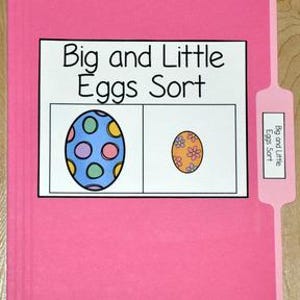 May include: A pink file folder with a label that reads "Big and Little Eggs Sort." The label shows a large, decorated egg next to a smaller egg. The tab on the right also has the text "Big and Little Eggs Sort."