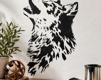 May include: A black wall decal featuring a stylized wolf head howling upward. The design consists of high-contrast, jagged black shapes against a white textured wall surface, creating a bold graphic silhouette of the animal's fur and features.