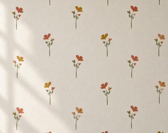 May include: A light beige wallpaper featuring a repeating pattern of small, hand-drawn style flowers in shades of terracotta, mustard yellow, and muted green. Each floral motif consists of a single stem with two small leaves and two petals.