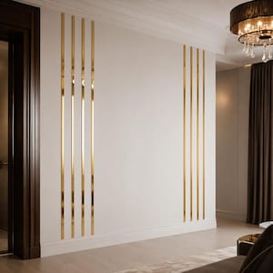 May include: A wall feature consisting of two sets of four vertical, narrow, reflective gold-toned metallic strips applied directly to a smooth, off-white interior wall surface, creating a symmetrical decorative paneling effect.