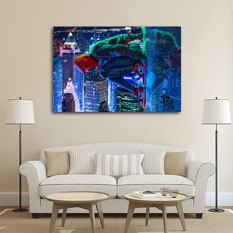 Puede incluir: Un lienzo muestra a un superh&eacute;roe con un traje verde y negro, zapatos rojos y una capucha naranja, aferrado a un rascacielos. El fondo presenta un vibrante paisaje urbano nocturno, con edificios iluminados y un cielo azulado.