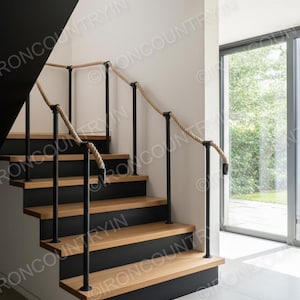 May include: A contemporary staircase with wooden treads and black risers. The handrail is made of natural rope and black metal posts. The design is minimalist, with clean lines and contrasting colours. The staircase is a stylish interior feature.