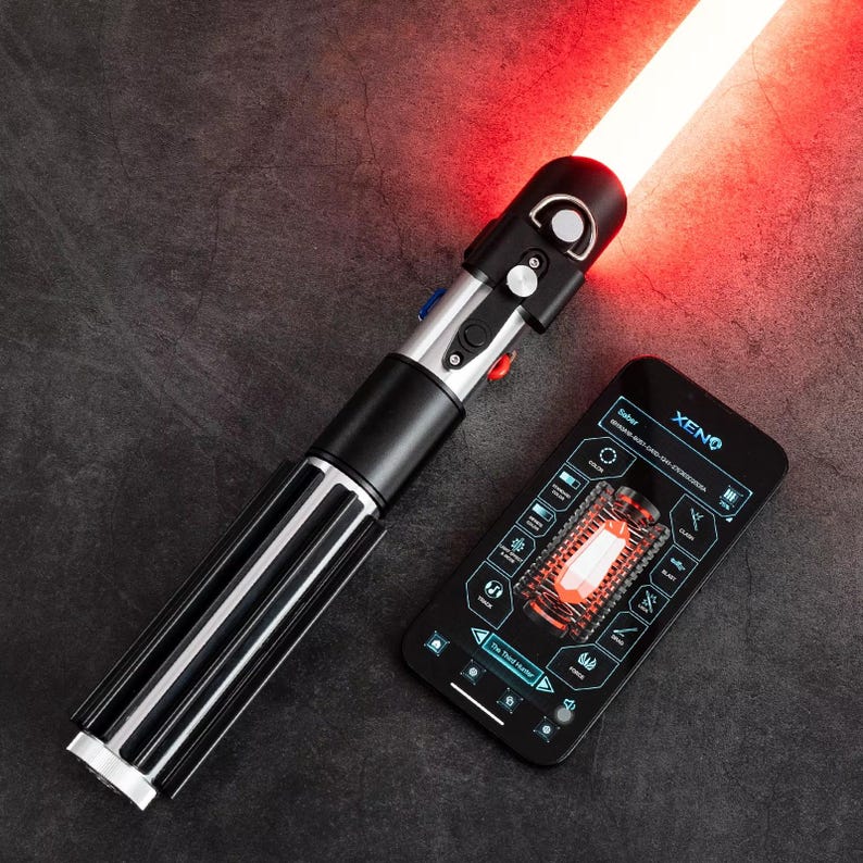 May include: A black and silver lightsaber with a red blade is next to a smartphone displaying a schematic. The lightsaber has a black handle with silver accents and a red glowing blade. The phone screen shows the word "XENO" and a diagram.