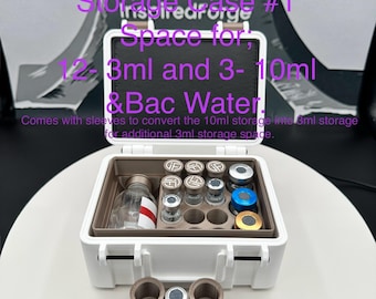 May include: A white rectangular storage case with a hinged lid containing a brown insert with circular slots for vials. The text reads: Storage Case #1, Space for 12- 3ml and 3- 10ml & Bac Water. Comes with sleeves to convert the 10ml storage into 3ml storage.