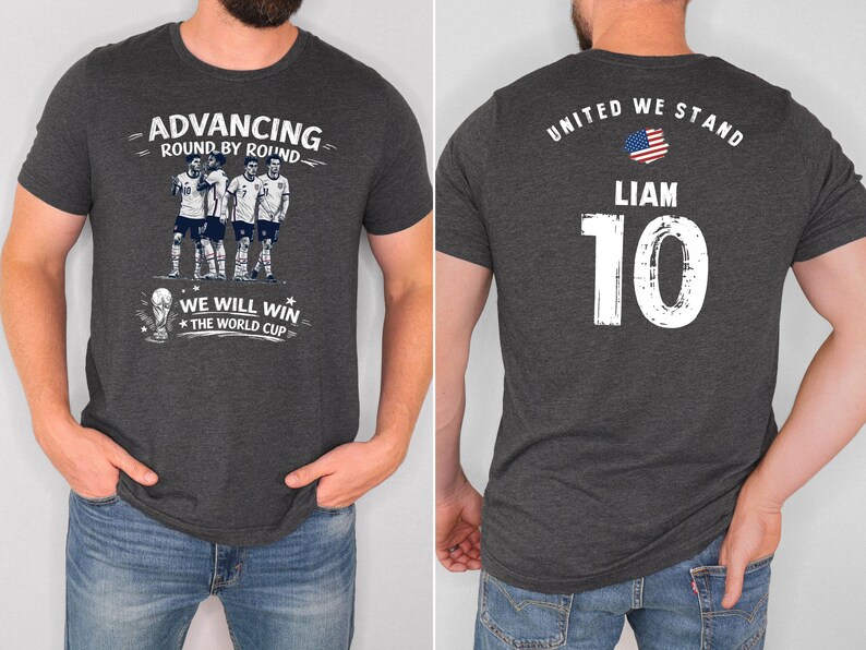 May include: Dark gray t-shirt with a soccer theme. The front features the text "Advancing Round by Round" and "We Will Win The World Cup" with a team graphic. The back displays "United We Stand", the name "Liam", and the number "10".