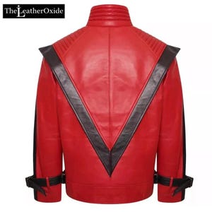May include: A red leather jacket with black detailing. The jacket has a high collar, quilted shoulder panels, and a black V-shaped design on the back. The sleeves have black stripes and buckle fastenings. The LeatherOxide logo is in the top left corner.
