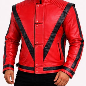 May include: A vibrant red leather jacket with black detailing. It has a stand-up collar, quilted shoulder panels, and a zip closure. Black stripes run across the chest and arms. The LeatherOxide logo is visible.