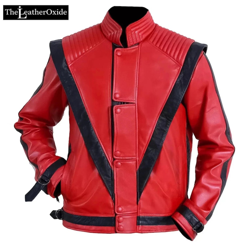 May include: A red leather jacket with black detailing. The jacket has a stand-up collar, quilted shoulder panels, and black stripes on the sleeves and front. It features a button-up front and buckle fastenings on the cuffs and waist.