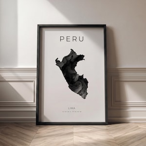 May include: A framed art print featuring a black and white abstract depiction of the country of Peru. The word "PERU" is at the top, with "LIMA" and coordinates below. The frame is black, and the background is white.