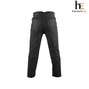 May include: Black trousers featuring a waistband with belt loops, two back pockets, and a straight-leg cut. The garment is displayed from the rear view, showcasing a matte texture and clean stitching details throughout the design.