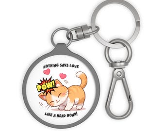 Llavero con forma de gato / "¡Nada dice amor como un cabezazo!" Acrílico blanco