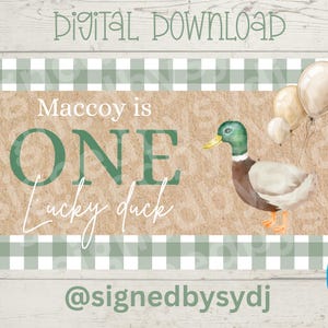 May include: Digital download birthday card with a watercolor illustration of a duck, balloons, and the text "Macccoy is ONE Lucky duck." The design includes a green and white checkered pattern and the Canva logo.