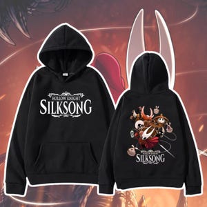 May include: Two black hooded sweatshirts. One features the text "Hollow Knight Silksong" in white. The other displays a graphic of characters from the game, with the text "Hollow Knight Silksong" below. Both have a front pocket.