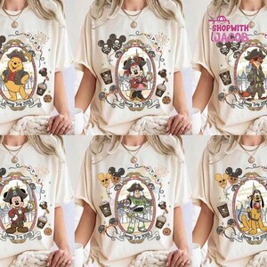 May include: Cream-colored t-shirts featuring various Disney characters in pirate attire. Each shirt has a framed character image, the text "Disney Trip 2026", and decorative elements like pirate flags and coffee cups.