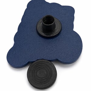 May include: A navy blue, cloud-shaped pin with a black threaded post and a separate black circular piece. The pin has a textured surface and is set against a white background. The pin is likely a decorative accessory.