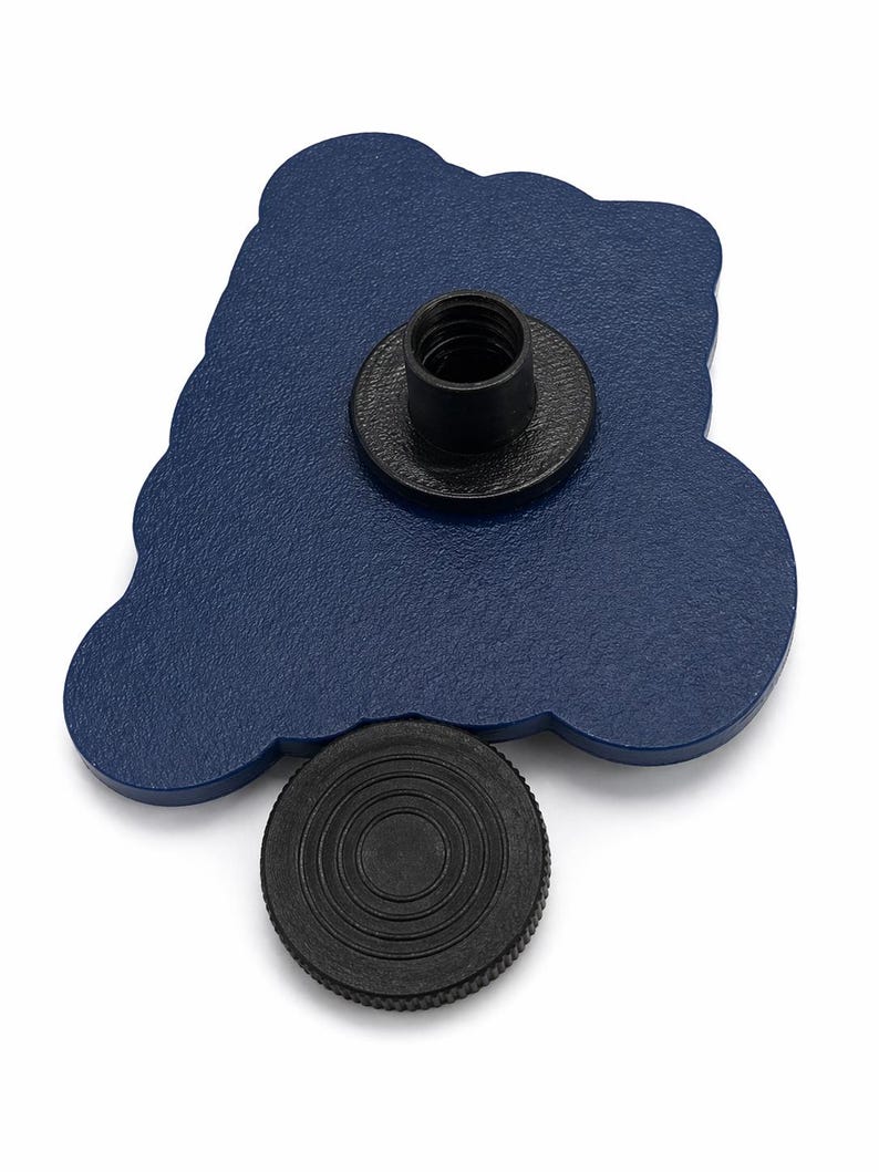 May include: A navy blue, cloud-shaped pin with a black threaded post and a separate black circular piece. The pin has a textured surface and is set against a white background. The pin is likely a decorative accessory.