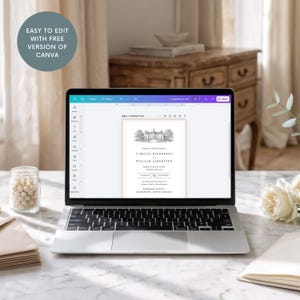 May include: A laptop screen shows a wedding invitation design with a traditional layout. The invitation includes a detailed illustration of a grand house, framed by a soft pink border. The text on the screen reads "EASY TO EDIT WITH FREE VERSION OF CANVA."