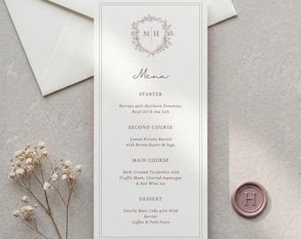 Plantilla elegante para menú de boda con monograma y escudo floral, color rosa pálido, editable en Canva.
