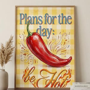 May include: A framed print with a red chili pepper on a yellow and white checked background. The text "Plans for the day: be Hot" is written in decorative lettering. The artwork has a vintage, rustic style, suitable for a kitchen or dining area.