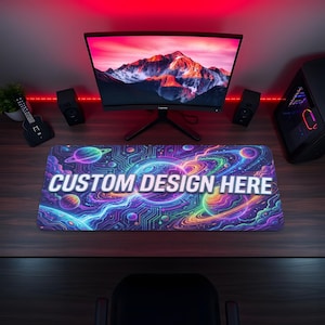 May include: A rectangular mousepad with a vibrant space-themed design featuring planets, galaxies, and circuit board patterns in shades of blue, purple, and green. The text "CUSTOM DESIGN HERE" is prominently displayed in white.