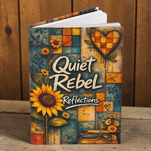 Puede incluir: Un diario de tapa dura titulado "Quiet Rebel Reflections" con un diseño de girasol y corazón. La portada presenta un patrón de patchwork en verde azulado, naranja y amarillo. El diario está abierto, revelando páginas blancas.