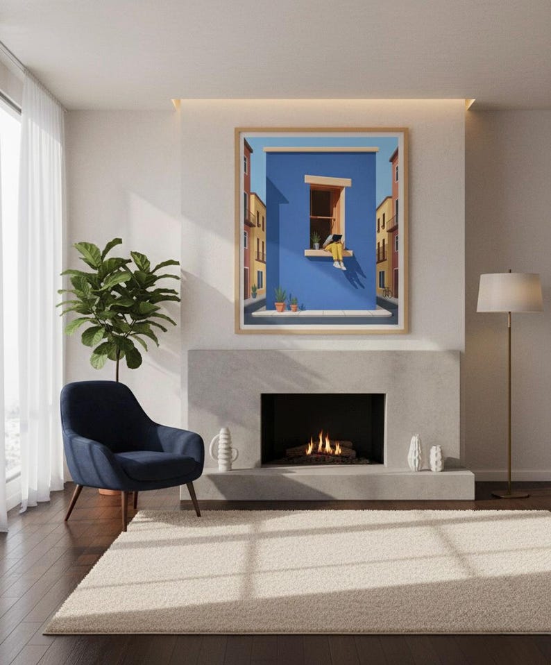 May include: A framed art print depicts a person sitting in a window against a blue wall, with buildings on either side. The artwork is displayed above a fireplace, with a blue armchair and a potted plant to the left. A floor lamp stands to the right.