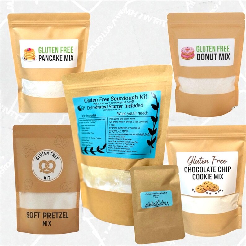May include: Assortment of gluten-free baking mixes in tan pouches. Includes pancake, donut, soft pretzel, sourdough, and chocolate chip cookie mixes. Each pouch has a label with the product name and a graphic. The sourdough kit includes a dehydrated starter.