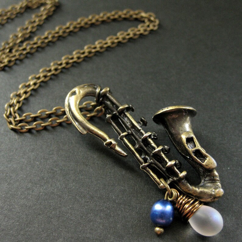 Saxophone Necklace. Musical Instrument Necklace with Frosted Teardrop and Blue Pearl. Handmade Jewellery. image 2