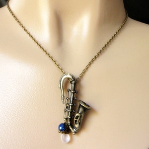 Saxophone Necklace. Musical Instrument Necklace with Frosted Teardrop and Blue Pearl. Handmade Jewellery. image 4