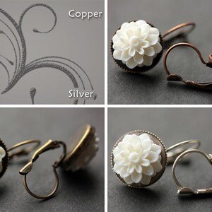 May include: A set of three pairs of earrings with white flower-shaped charms. The earrings are available in silver, bronze, and copper.