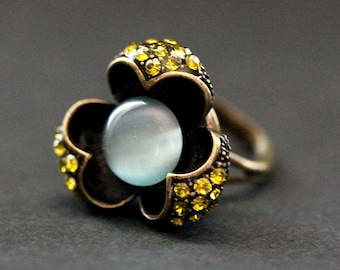 Lotus Flower Ring in Bronze. Rhinestone and Cats Eye Button Ring in Olive and Blue. Adjustable Sizing.
