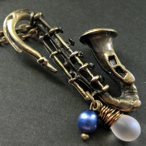 Saxophone Necklace. Musical Instrument Necklace with Frosted Teardrop and Blue Pearl. Handmade Jewellery. image 1