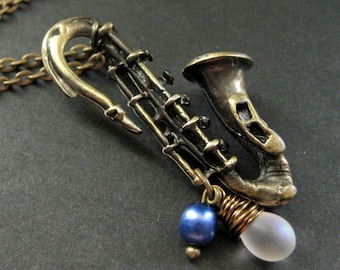 Saxophone Necklace. Musical Instrument Necklace with Frosted Teardrop and Blue Pearl. Handmade Jewellery.