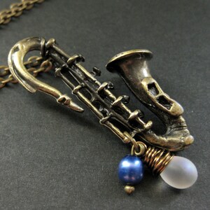 Saxophone Necklace. Musical Instrument Necklace with Frosted Teardrop and Blue Pearl. Handmade Jewellery. image 3