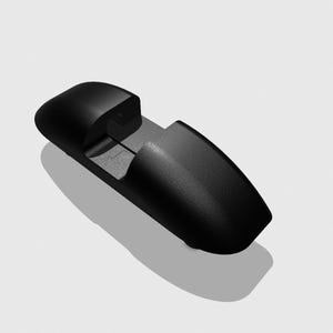 May include: A black, aerodynamic-shaped object with a textured surface. The object has a central cutout and a rounded top. The item casts a shadow on a white background, suggesting a 3D design.