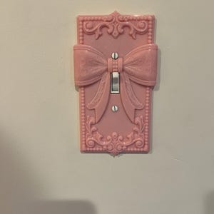 Transform a boring essential into a focal point with this vintage-inspired bow light switch cover.