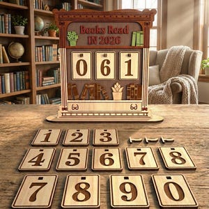 May include: Wooden book counter displaying "Books Read IN 2026" and the numbers 061. Includes individual number tiles from 0-9. The counter features decorative book and plant motifs.