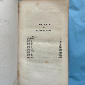 May include: Open book with the contents page of "Paradise Lost" visible. The page is aged with visible wear and tear. The text includes "CONTENTS OF PARADISE LOST" and a list of book titles and page numbers.