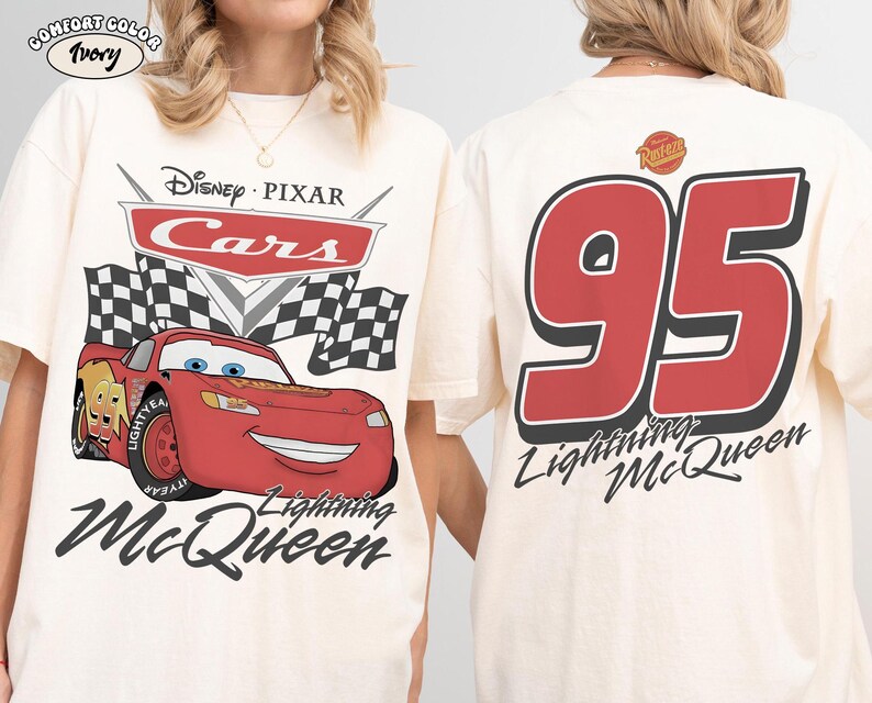 May include: An ivory t-shirt featuring a Disney Pixar Cars graphic on the front with Lightning McQueen, checkered flags, and the text Lightning McQueen. The back displays the large red number 95 with the text Lightning McQueen and Rust-eze logo.