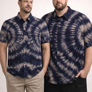 May include: Two men wearing short-sleeved button-down shirts with a navy blue and beige tie-dye pattern. One man is wearing khaki pants, and the other is wearing black pants. The shirts have a classic collar and button closure.