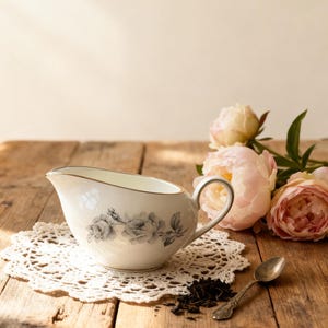 May include: A set of three ceramic mugs with a speckled, matte finish. Each mug features a different color: light blue, cream, and gray. The mugs have a simple, modern design and a comfortable handle.