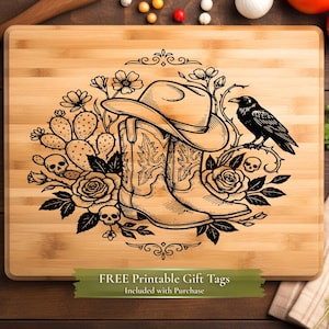 May include: A rectangular bamboo cutting board with a black graphic design. The design features a cowboy hat, boots, a raven, roses, cacti, and skulls. The text "FREE Printable Gift Tags Included with Purchase" is at the bottom.
