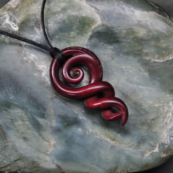 Maori koru & Celtic twisting vine~ symbolising eternal bonding. Hand carved naturally stained bone
