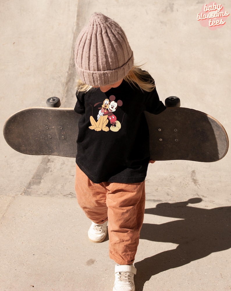 May include: A white ceramic mug with a black handle and the text "But First, Coffee" in a bold, black font. The mug is set against a blurred background, highlighting its clean design.