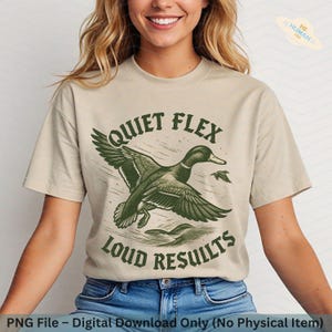 May include: Beige t-shirt with a green graphic of a flying duck and the text "QUIET FLEX LOUD RESULTS". The design features a detailed illustration of the duck in flight, with the text in a bold, vintage style. The shirt is a digital download.